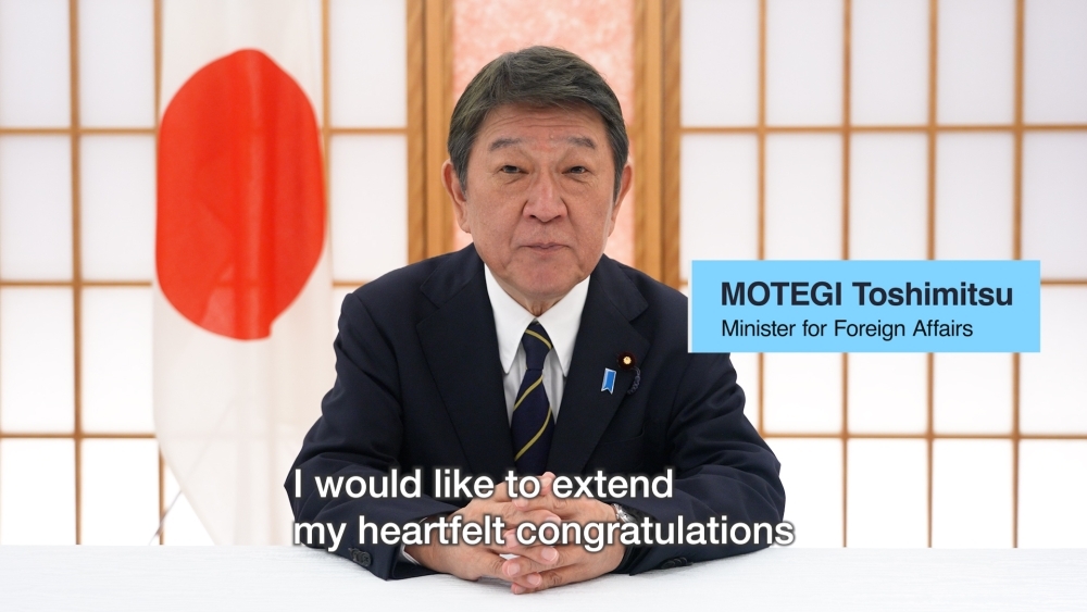 Minister MOTEGI giving message 