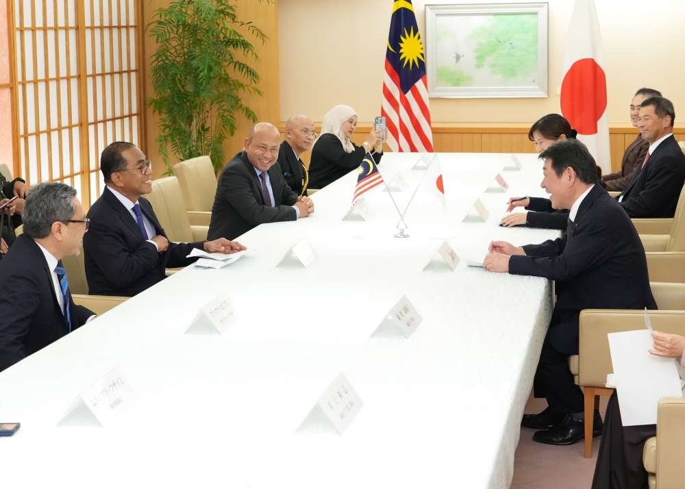 Foreign Minister Motegi holding a meeting with Defence Minister Khaled
