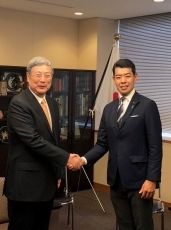 黄中国太平洋経済協力全国委員会名誉会長と握手する辻外務大臣政務官