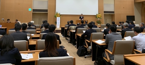 (写真1)開会挨拶を行う尾身外務大臣政務官