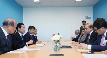 テーブルにつき、会談を行う、岸田総理とシャリフ首相の様子