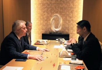 テーブルにつき、意見交換を行う、山田副大臣とマコーリフ元州知事の様子