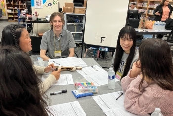 学生たちが机でお互いへの自己紹介を行っている様子