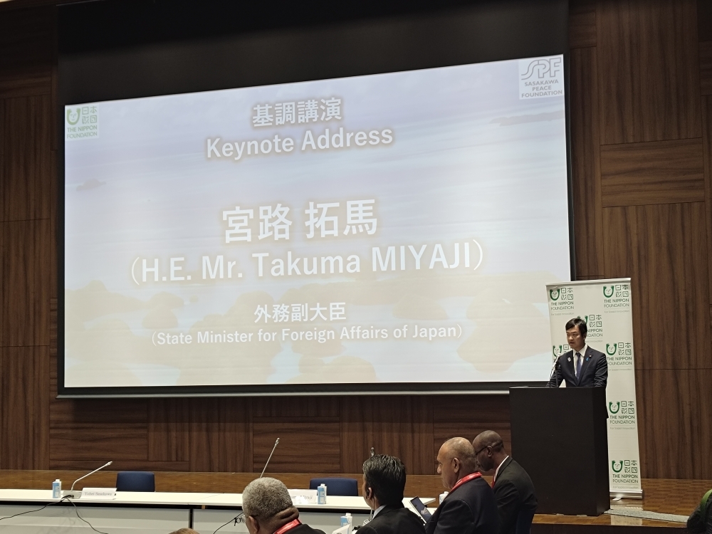 挨拶を行う宮路外務副大臣と、宮路副大臣の名前が示された大きなパネル