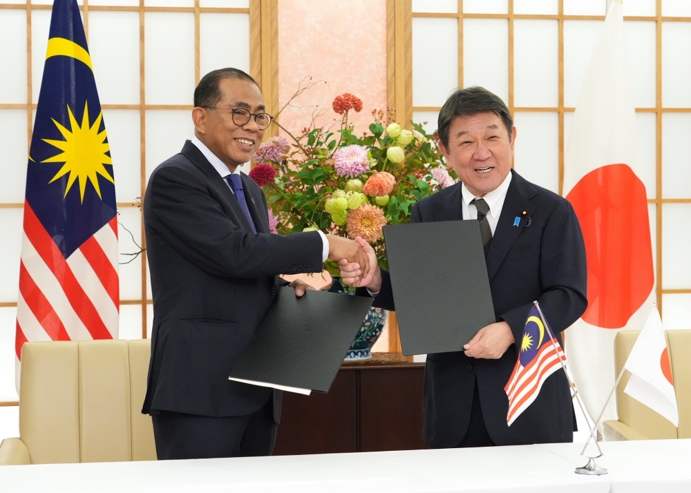 書簡を交換後に握手をする茂木外務大臣とカレド・マレーシア国防大臣