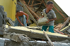 （写真15）被災した家の瓦礫を撤去する家族