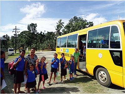 日本が供与したスクールバスで登校するパラオのアイメリーク小学校のこどもたち