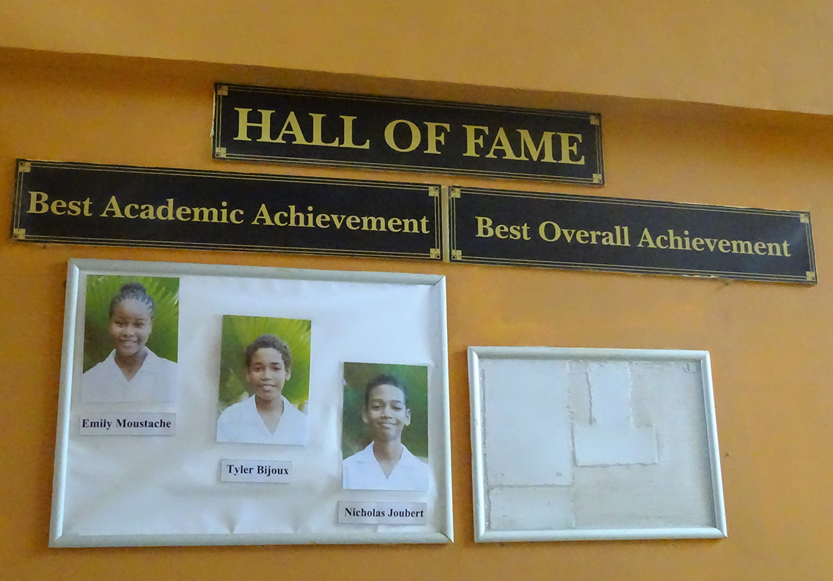 壁に写真が貼られ表彰される生徒たち