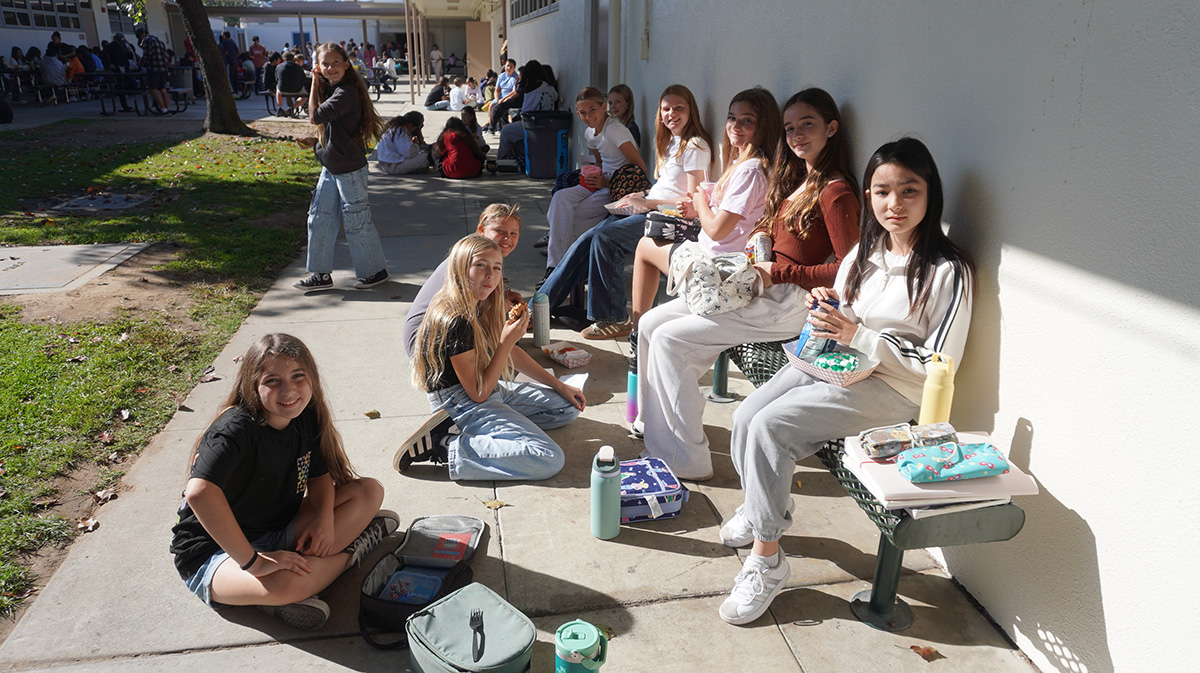 中庭に座ってお昼を食べている生徒たち