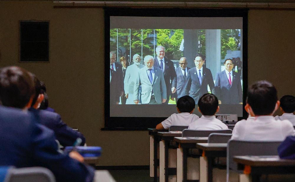 Children listen to a Summit-related lecture