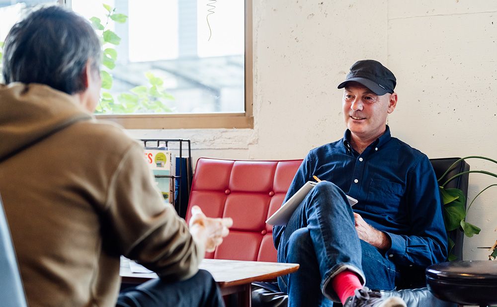 Paul sitting on the sofa for an interview.