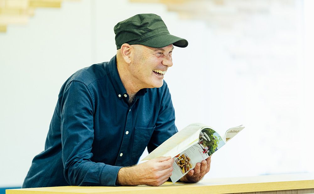 Paul smiles with "Get Hiroshima" in his hand.