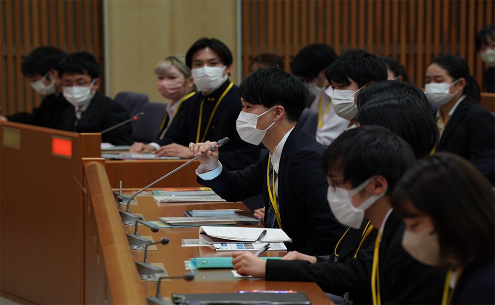 Students asking questions in plenary session
