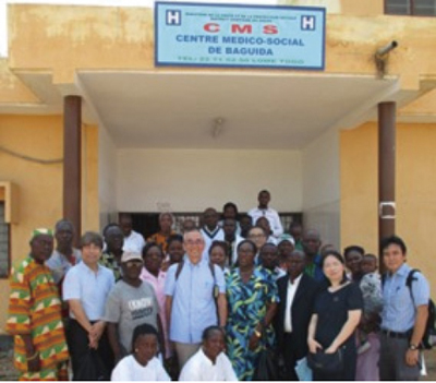 A photo of local officials and the evaluation team at the health center reconstructed with counterpart funds.
