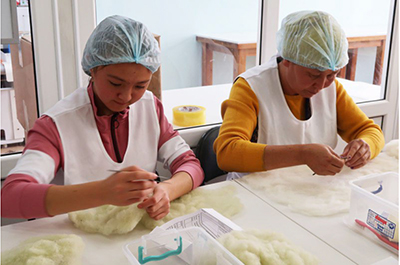 A photo of “Issyk-Kul Brand” in the Kyrgyz Republic Women working in a felt workshop