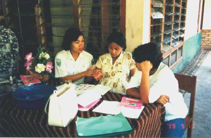 Medical staffs instructing a pregnant woman using MCH