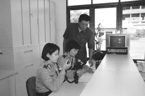 A scene of using a wireless device (the Indonesian National Police Reform Assistance Program)