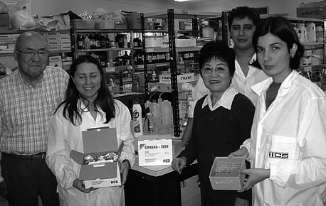Mr. Sendo and IICS researchers holding diagnosis kits