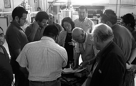 Mr. Kurihara giving guidance on the assembly of press machinery.