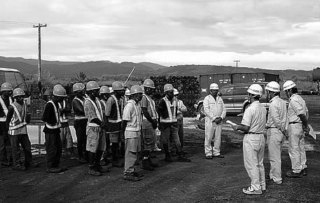 Workers confirming the work plan at a morning meeting.