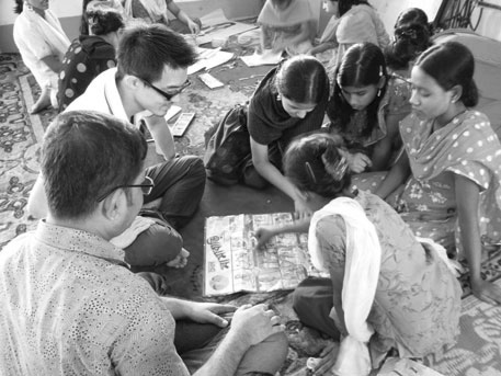 Girls learning how to use the education material (second from left, Mr. Sugahara) (Photo: SHAPLA NEER)