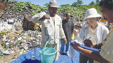Ms. Kawabata instructs a Ministry of Health official on methods of determining waste type and weight. (Photo: Yurie Kawabata)