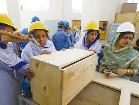 Female students participating in woodwork exercise at the Government College of Technology Railway Road, Lahore in Pakistan. (Photo: Minoru Ito)