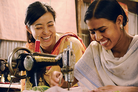 Ms. Toki (left) teaches a union member how to use a sewing machine. (Photo: Miwa Toki)