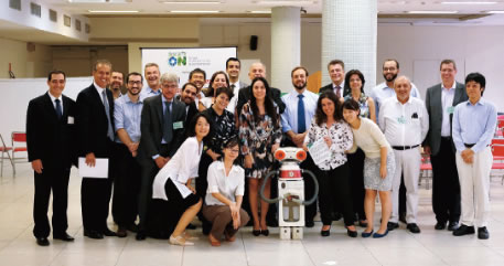 Opening ceremony for the pilot project. Members surround the mascot Descartes. (Photo: JICA)