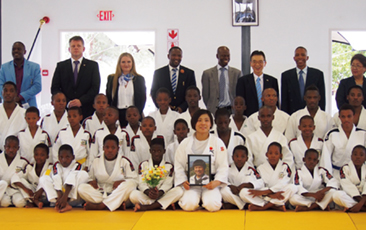 Ms. Tachimoto holding a picture of the late Mr. Itsubo with Judo officials at the completed dojo