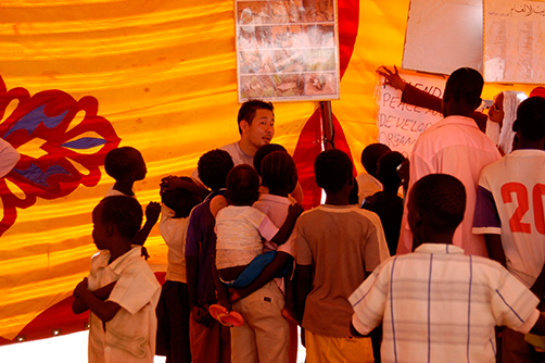 Conducting mine risk education for children at an Internally Displaced Persons (IDPs) camp in the outskirts of Khartoum, Sudan (author center) (Photo: UNMAS)