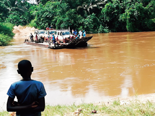 On the way to visit refugees, a ferry carries UN vehicles across a river with no bridge (Photo: KIMURA Makiha)