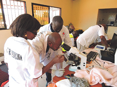 Former JICA training participants conducting maintenance on medical equipment in Angola (Photo: JICA)