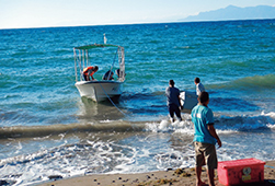 Transporting medicines and vaccines to coastal villages using the small boat provided by the project (Photo: SHARE)