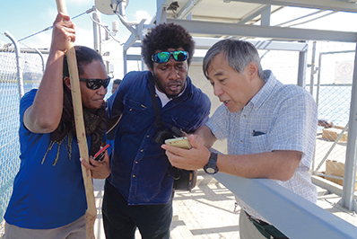 Photo of Checking images of Tsunami Watch Cameras after their installation as part of the “Project for Enhancing the Capacity of Issuing Earthquake, Tsunami and Storm Surge Information,” a technical cooperation project currently underway in Vanuatu (Photo: JICA)