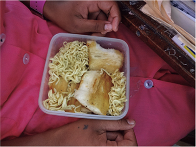 A lunch box of instant noodles and fried cassava tuber