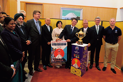 Standing around the World Cup Trophy at a reception on the previous Emperor's Birthday (December 7, 2018, at the residence of the Japanese Ambassador to Nepal)