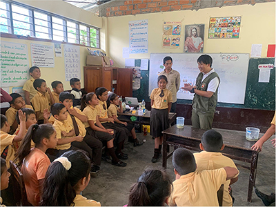 Conducting a class on the importance of conserving water resources at an elementary school near the protected area (the author is in the back on the right)