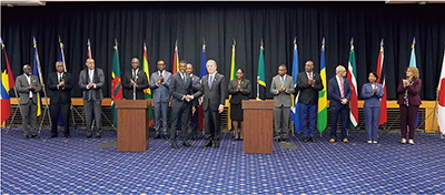Foreign Minister Iwaya shakes hands with Foreign Minister Vince Henderson of Dominica (Co-chair) and foreign ministers of CARICOM member states (December 14, Tokyo)